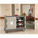 A Cambro granite gray meal delivery cart with trays on it.