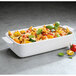 A white Villeroy & Boch rectangle baking dish with pasta and vegetables in it.