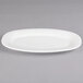 A Villeroy & Boch white porcelain oval platter with a small rim on a white surface.