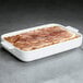 A Villeroy & Boch white porcelain rectangle baking dish with food in it.
