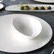 A white Villeroy & Boch Sedona porcelain bowl on a plate.