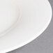 A close up of a white Villeroy & Boch porcelain plate with a white rim.