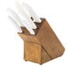 A white Dexter-Russell knife block with white knives in it.