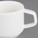 A close-up of a Villeroy & Boch white porcelain mug with a handle.