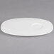 A white porcelain Villeroy & Boch oval party plate with a small circle on it.