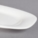A close-up of a Villeroy & Boch white porcelain oval platter with a small rim.