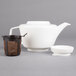 A Villeroy & Boch white porcelain teapot with a filter.