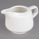 A white Villeroy & Boch porcelain creamer with a handle.
