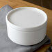 A white Villeroy & Boch porcelain serving dish with lid on a table with a cloth