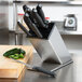 A Dexter-Russell knife block with knives on a counter.