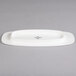 A white porcelain Villeroy & Boch oval plate with black text on it.