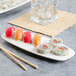 A Villeroy & Boch white porcelain oval plate with sushi and chopsticks.