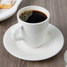 A cup of coffee on a white Villeroy & Boch porcelain saucer.