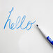 A blue Expo fine point marker writing "hello" on a white board.