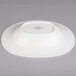 A white Villeroy & Boch porcelain oval bowl on a gray surface.