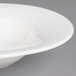 A close up of a Villeroy & Boch white porcelain oval bowl with a rim.
