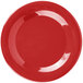 A red Carlisle Sierrus melamine plate with a wide rim.