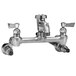 A chrome Fisher wall mounted service sink faucet with two lever handles.