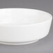 A Villeroy & Boch white porcelain bowl with a rim on a gray surface.