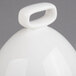 A white porcelain bell cover with a handle.