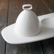 A white porcelain bell cover on a table.