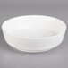 A Villeroy & Boch white porcelain salad bowl on a gray surface.