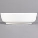 A Villeroy & Boch white porcelain salad bowl on a gray background.