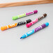 A group of Expo 2-in-1 dry erase markers with chisel tips in assorted colors on a table.
