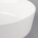 A close-up of a Villeroy & Boch white porcelain salad bowl with a rim.