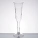 A clear plastic Fineline Flairware champagne flute on a table.