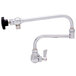 A Fisher chrome wall mounted pot filler faucet with a double-jointed control spout.