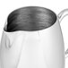 A Vollrath stainless steel creamer pitcher with a handle.