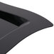 A black plastic rectangular plate with a curved edge.