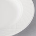 A close-up of a white Villeroy & Boch porcelain plate with a circular design.