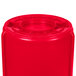 A red Rubbermaid BRUTE 55 gallon barrel with a lid.