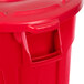 A red Rubbermaid BRUTE round trash can with a lid.
