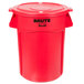 A red Rubbermaid BRUTE round plastic trash can with lid.