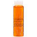 A PAYA Papaya Conditioning Shampoo bottle with orange liquid.