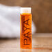 A close up of a small PAYA Papaya Conditioning Shampoo bottle.