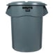 A gray plastic Rubbermaid Brute trash can with a lid.