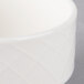 A close-up of a white Villeroy & Boch porcelain soup cup with a white rim.