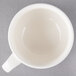 A Villeroy & Boch white porcelain cup on a gray surface.