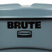 A Rubbermaid Brute 20 gallon round gray trash can with a black lid and logo.