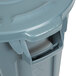 A close up of a gray Rubbermaid BRUTE trash can with a lid and handle.