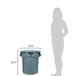 A woman standing next to a Rubbermaid gray plastic trash can.