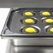 A Vollrath Egg Poacher pan with eggs in it.