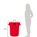 A woman standing next to a red Rubbermaid BRUTE trash can.