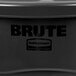 A black Rubbermaid BRUTE round trash can on a counter.