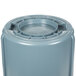 A grey Rubbermaid BRUTE 44 gallon round plastic container with a lid.
