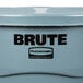 A Rubbermaid BRUTE 44 gallon trash can with lid on a counter.
